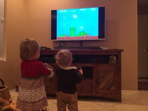 Uncle Andy brought an old-school video game gadget. Here, Emma and Tyler are playing Super Mario Bros.